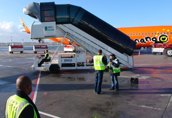 ACSA staff working next to a Mango plane at Cape Town airport