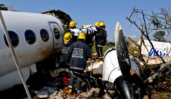 rescue workers carry a survivor out of the Airlink wreckage
