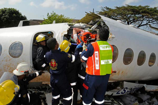 a survivor is carried out of the wreckage of Airlink flight 8911