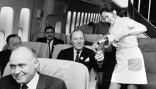 Air hostess pouring a drink