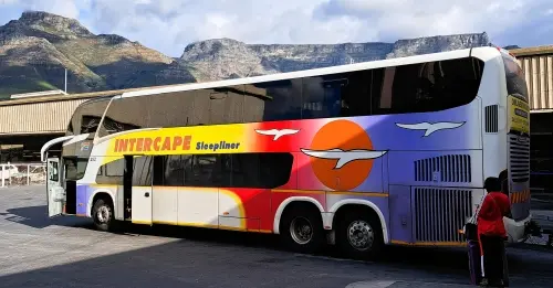 Intercape Sleepliner coach parked at Cape Town station with Table Mountain in the background