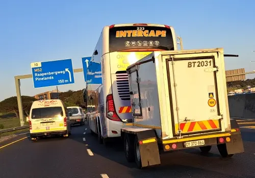Intercape bus and trailer passing the Pinelands (Cape Town) turnoff on the N2 national road