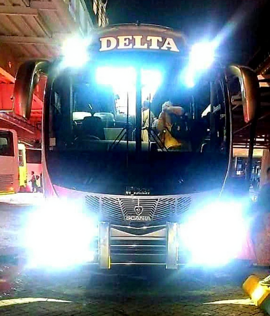Delta Coact at nighit; parked, fronton view with lights on