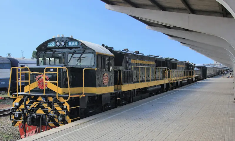 Rovos Rail train waiting under the curved concrete roof at TAZARA Railway Station in Dar es Salaam