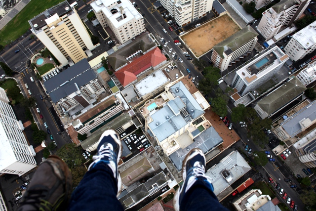 feet danging above Sea Point in a paraglider